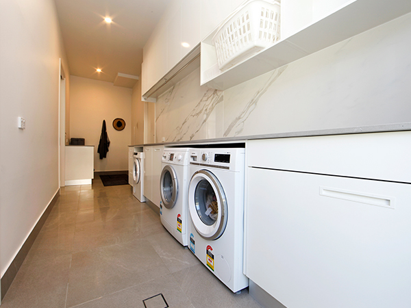 Laundry cabinets providing organised storage in a modern laundry room.